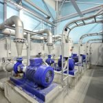 new shiny pipes and large pumps in industrial boiler room